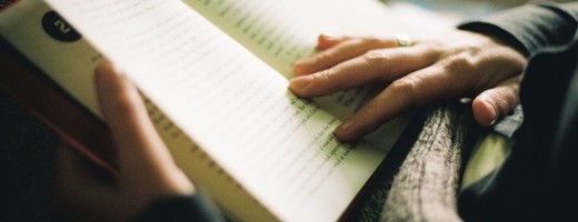 Woman reading a book, indoor light, hands close-up